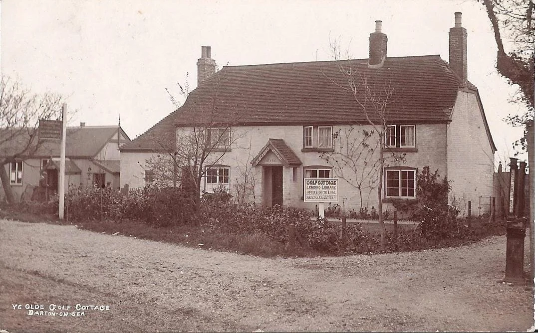 Black-and-white photo of a cottage with a sloping roof, chimneys, and a sign reading Tea Room in front. Trees and shrubs line the garden. A smaller building is to the left. Text reads Ye Olde Golf Cottage, Barton-on-Sea.