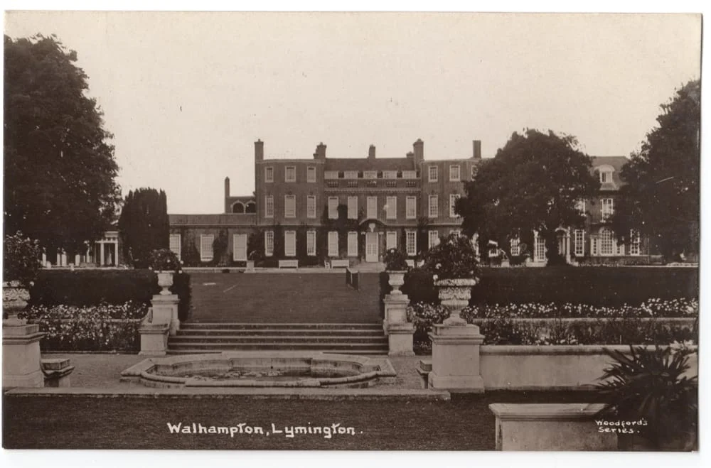 A sepia photograph of a large, elegant manor house with multiple chimneys, set behind landscaped gardens, stairs, and a circular fountain. The text at the bottom reads Walhampton, Lymington.