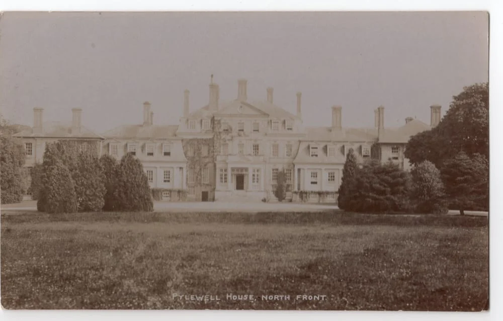 Sepia-toned photo of a large, stately mansion with multiple chimneys and ivy on the facade, surrounded by manicured lawns and trees. Text at bottom reads Pylewell House, North Front.