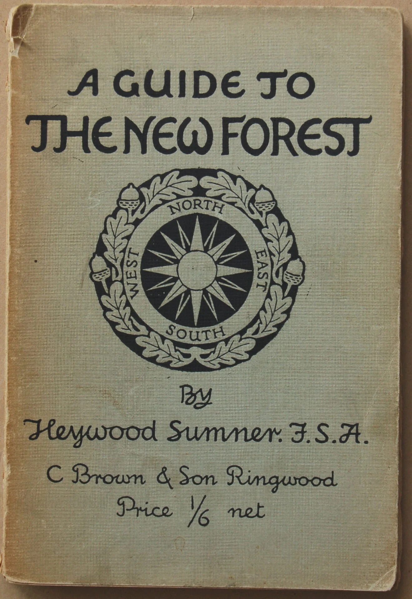A vintage book cover titled A Guide to the New Forest by Heywood Sumner, featuring a compass rose surrounded by a laurel wreath and publisher details: C Brown & Son Ringwood, Price 1/6 net.