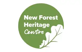 Logo of the New Forest Heritage Centre with white text on a green circle, featuring an outline of an oak leaf at the bottom right-hand corner.